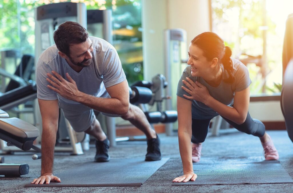 bigstock-Couple-Exercise-Together-In-Gy-368616523